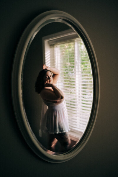 woman in an oval mirror