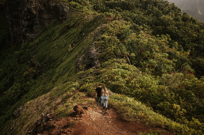 man and woman walking down a lush green path
