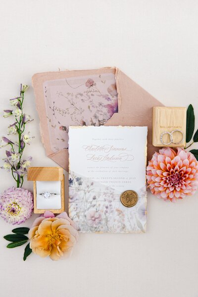 Custom invitation card flat lay with flowers