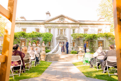 A wedding ceremony is captured by Liriodendron Mansion Wedding Photographer