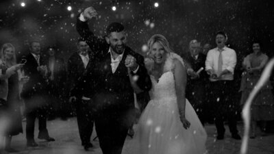 couple embracing in front of reception hall