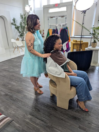 Personal stylist draping color swatches over a seated client during an in-person session in Philadelphia