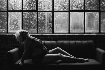 woman sitting on couch, leaned back, head back