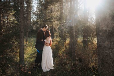 A bride and groom walk up the aisle after getting married, being showered in flower petals.