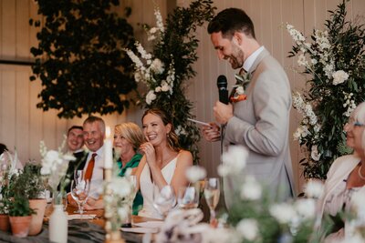 bride laughing during groom speech-1