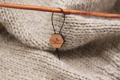 yarn with a wooden block charm on a string