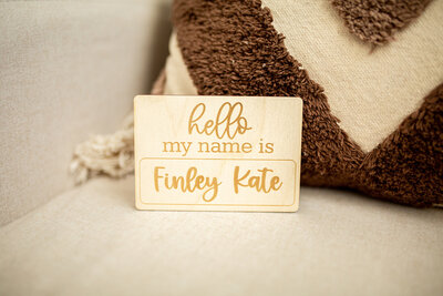 wooden name card on bed