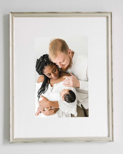 photo of newborn family holding their baby
