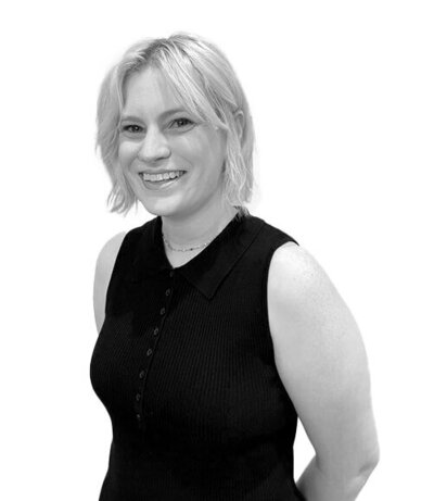 Salon Assistant with long straight hair, wearing a black blazer and necklace, showcasing a professional and approachable demeanour.
