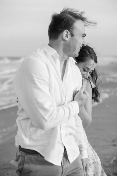 couple playfully walking at jersey shore