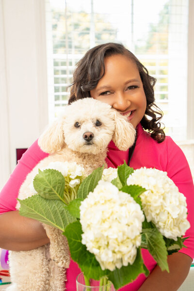 Photo of Brenda holding her puppy, owner of Platinum Key Weddings