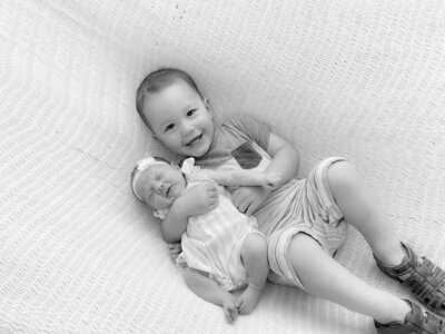 Hope's two children snuggling each other.