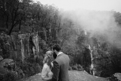 Bride and groom kissing on cliff at their souther highlands elopement