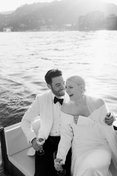 black and white image of couple on boat on Lake Como