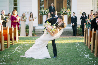 Couple kissing in the wedding aisle