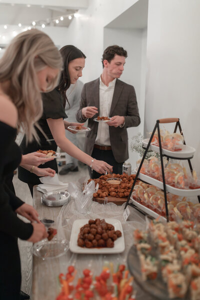 People gathering and eating prepared party food