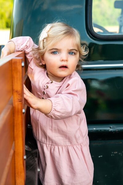 Little Girl Posing in Back of 1950's Green Chevy Truck - Jennifer Mummert Photography