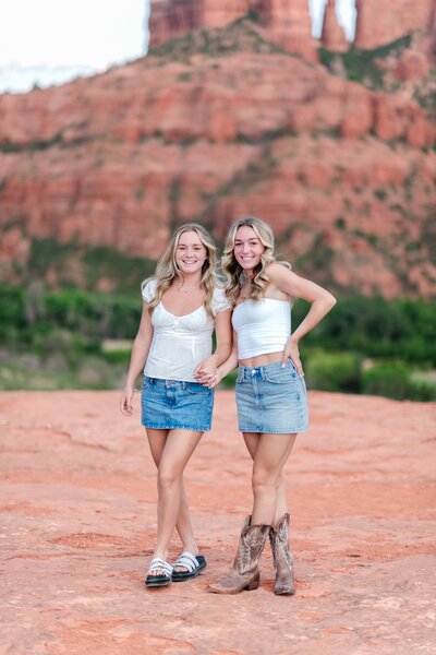 sisters posing in sedona az for their senior photos near bell rock