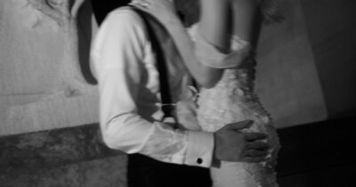 bride and groom embrace in black and white