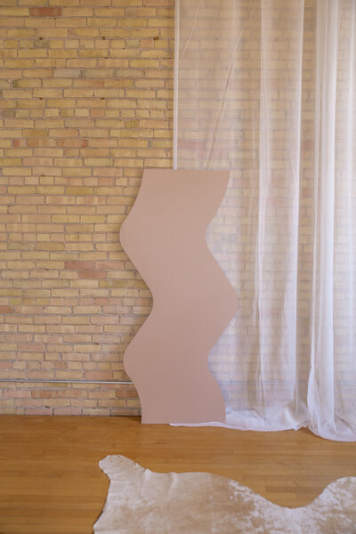 A six foot brown zig zag backdrop set up against a brick wall.
