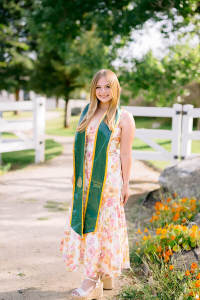 Female Cal Poly Senior posing for a photo at the Madonna Inn Secret Garden 
