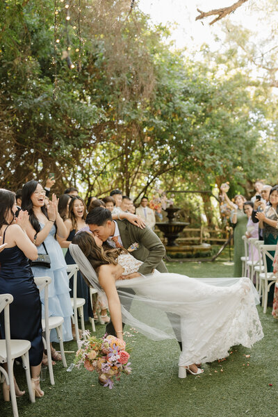Couple kissing in the aisle at green gables