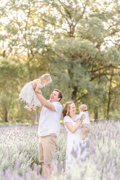 young caucasian family frolicking in a Brisbane lavender field Sirromet