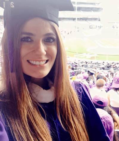 Madison beaming in her purple graduation cap and gown, celebrating her NYU master’s graduation at Yankee Stadium.