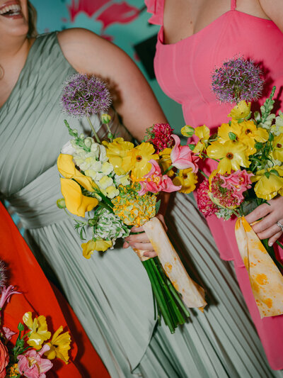 colorful bouquet against a green bridesmaid dress