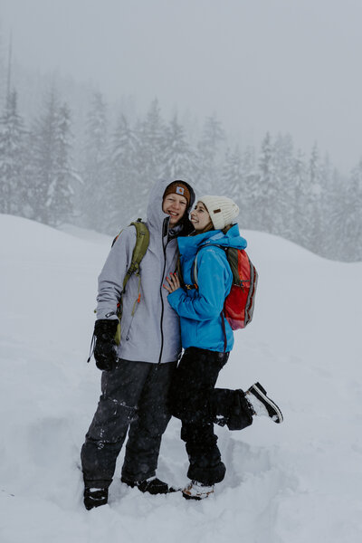 Hannah and Adam posing in a snow storm in the mountains