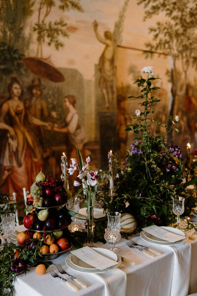 A small wedding reception table with elaborate centerpieces 