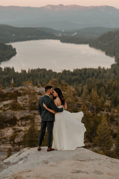 bride and groom kissing In front of donner lake in lake tahoe california
