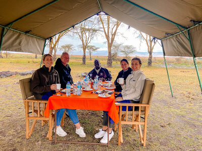 Family eating a meal in the Serengeti