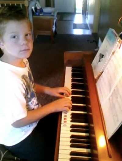 Child playing piano - Selah Music Ankeny