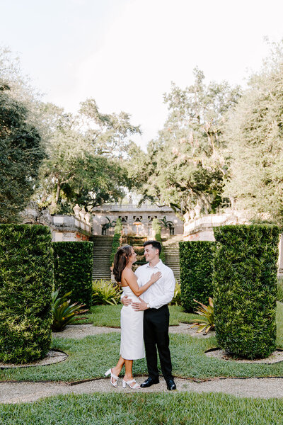 couple smiling in nyc garden.