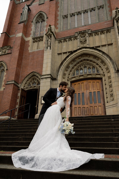 bride and groom kissing under veil