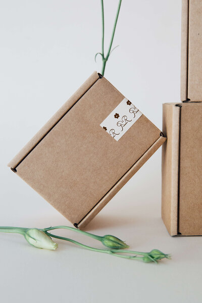 a shipping box next to white flowers
