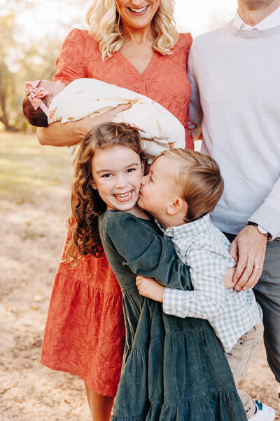 family holding hands and walking during a family session
