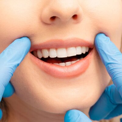 Prosthodontist evaluating a patient's healthy smile that was referred to us as part of our prosthodontics referrals system for restorative care at Peak Prosthodontics, a clinic located in Lethbridge, Alberta.
