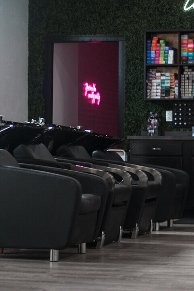 A row of four shampoo stations in a salon