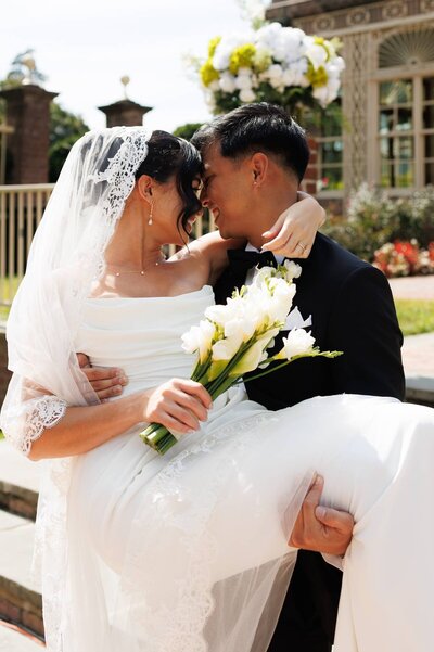 Bride and groom posing at sunset with tropical palms in the background at a South Florida destination wedding.