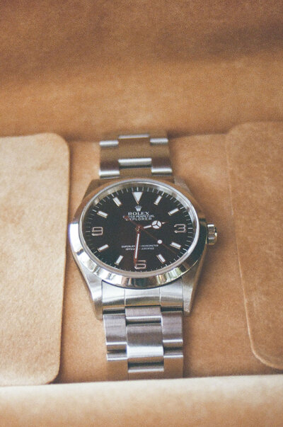 groom flat lay rolex watch captured on 35mm film detail photograph in austin texas 
