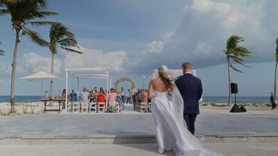 Bride and groom kissing on a Cancun beach at sunset.
