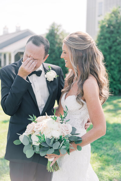 Groom wiping tears after first look at Rosewood Farms wedding, PA.
