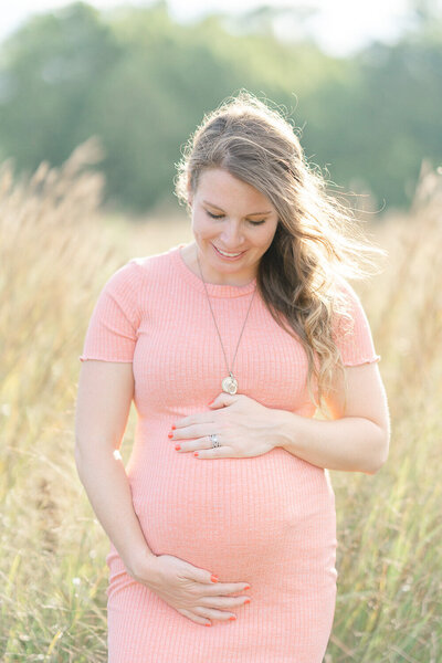 expecting mom looking at her belly during Leesburg, Virginia photography