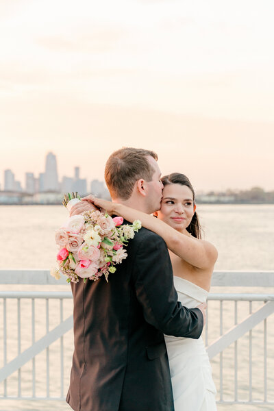 a bride and groom pose at clarks landing in new jersey