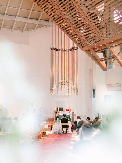 church wedding photography of bride and groom sitting at the altar