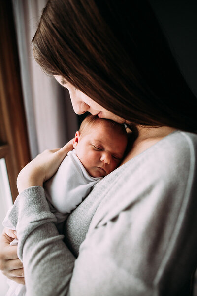 Chelsey and her baby girl pose for an image during her newborn session