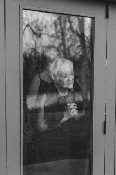 grandma looking out the window on brides wedding day