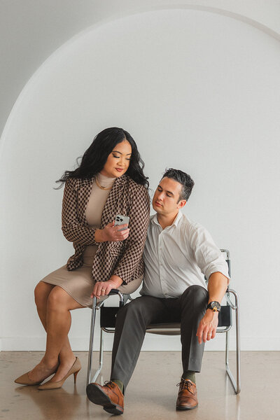 Two people look at a phone